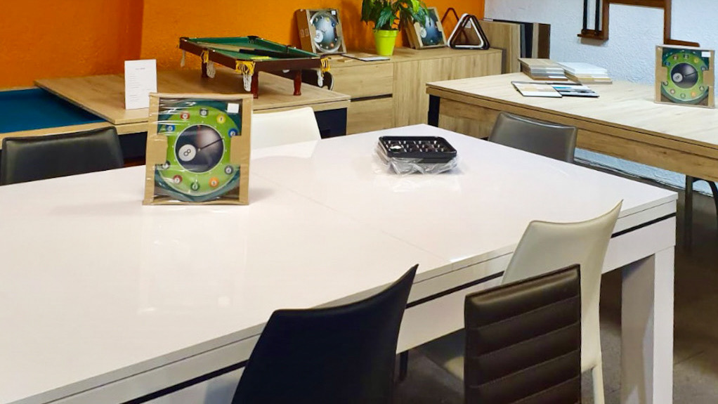Cette table laquée blanche est le billard Novea recouvert de son plateau en 2 parties, comme celui aperçu derrière dans une finition chêne naturel parmi les nombreux choix de finitions visibles dans le showroom Eurobillards de Mulhouse